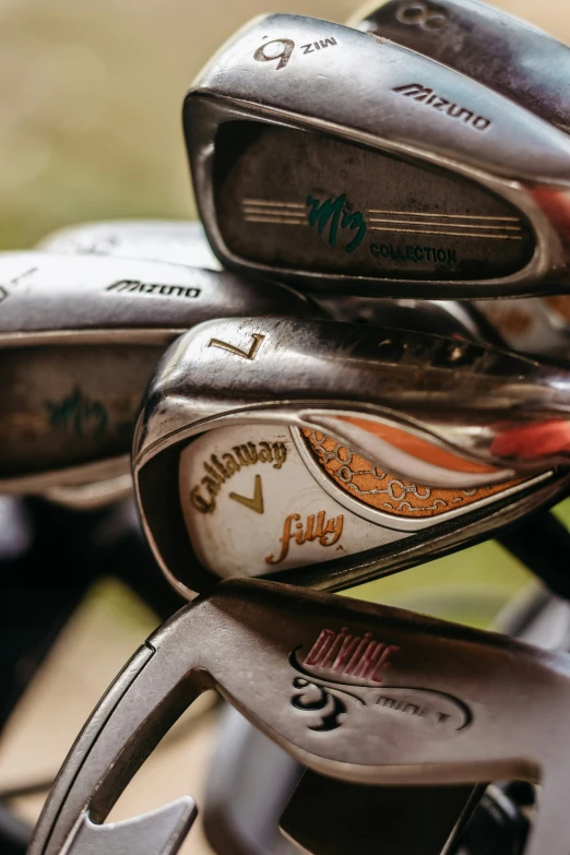 several golf clubs sitting on top of each other