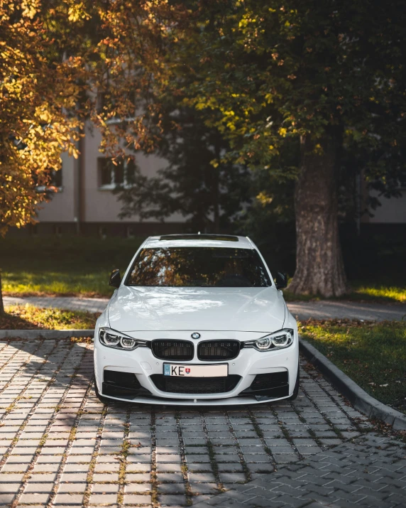 a white car parked in the middle of a driveway