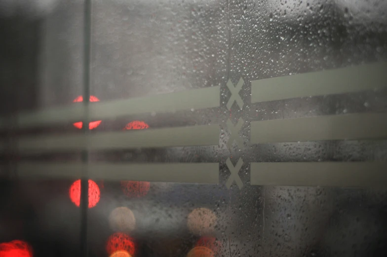 a city scene through a rain covered window