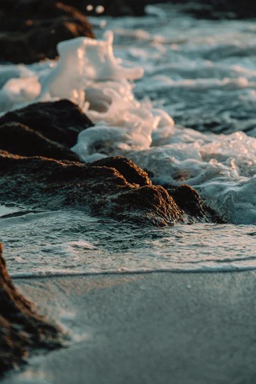 a small wave coming towards the shore with foam in it