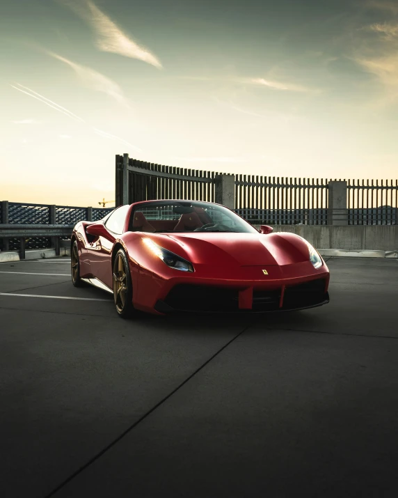 a large red sports car parked in a parking lot