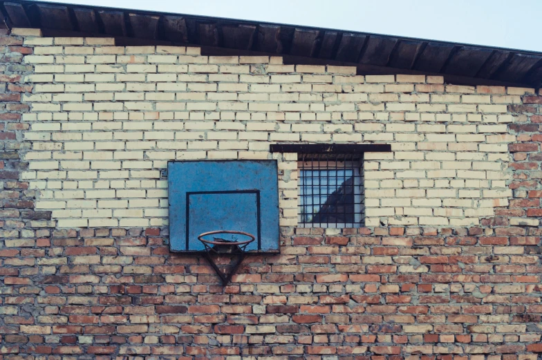 the basketball hoop is in front of the blue window