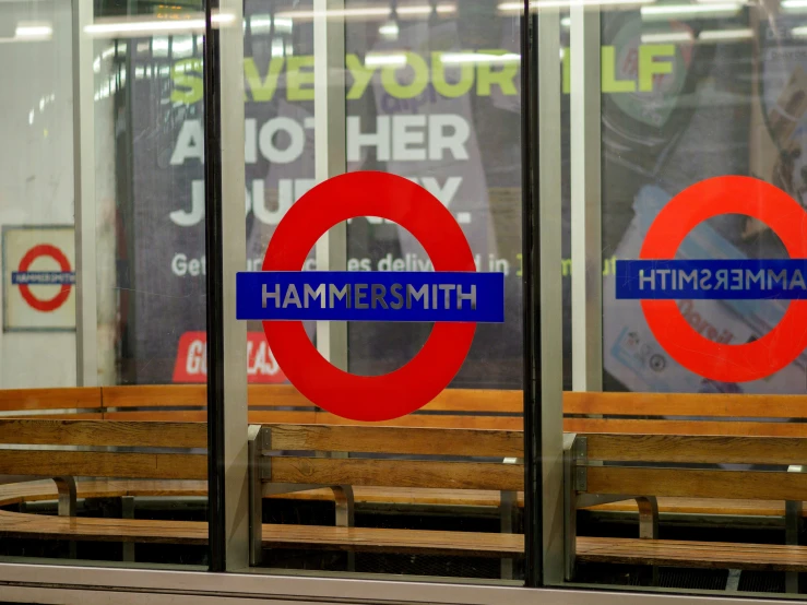 a view of a window with a double - decker bus station sign