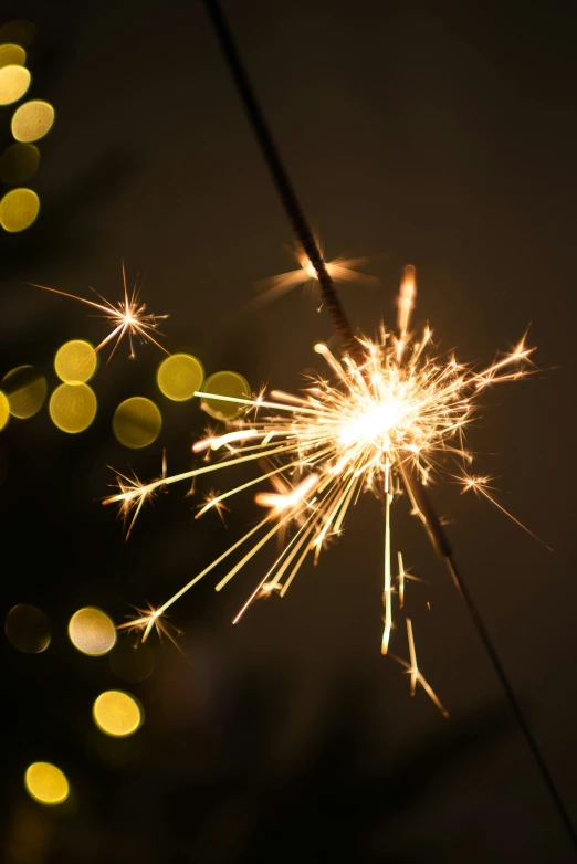 a sparkler is lit up and in the dark