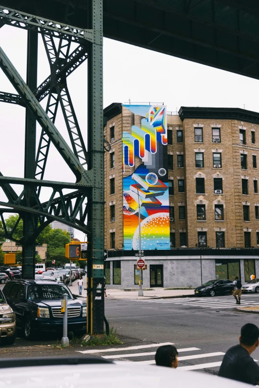 the mural is painted on a building over the road