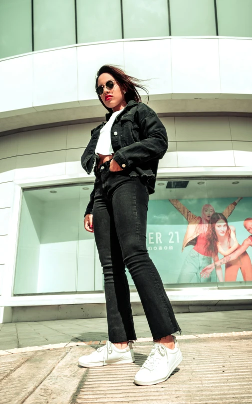 a woman standing in front of a giant window