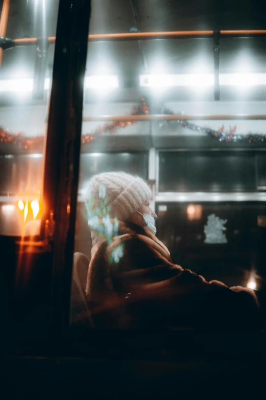 a woman is waiting on a bus at night