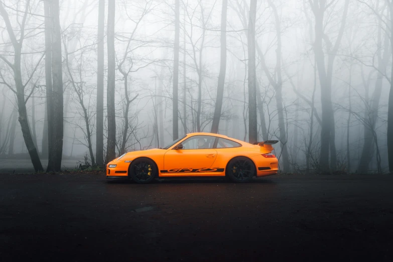 a car sits in the middle of an area surrounded by trees