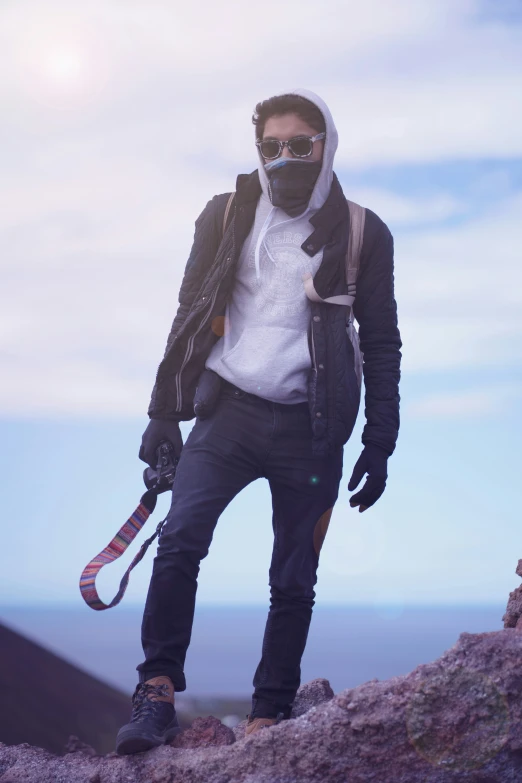 a man wearing ski gear on top of a hill