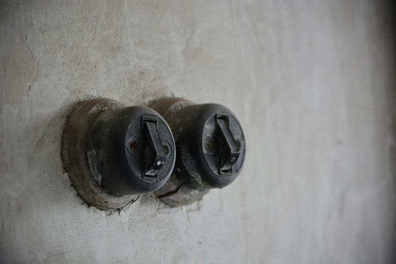 three electrical wires on a wall next to each other