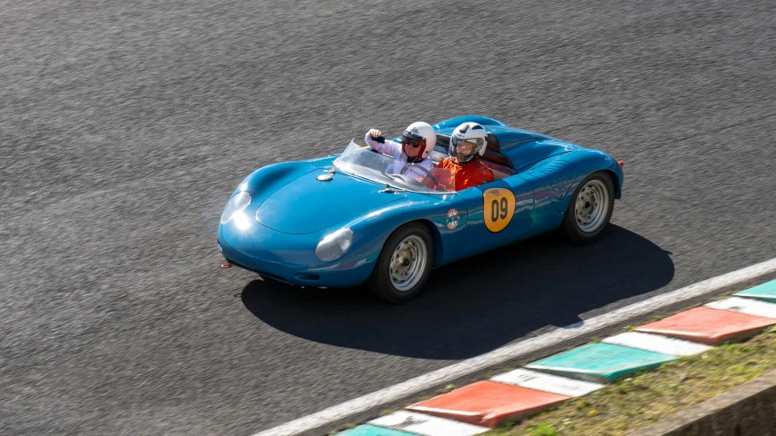 a group of people in a blue race car