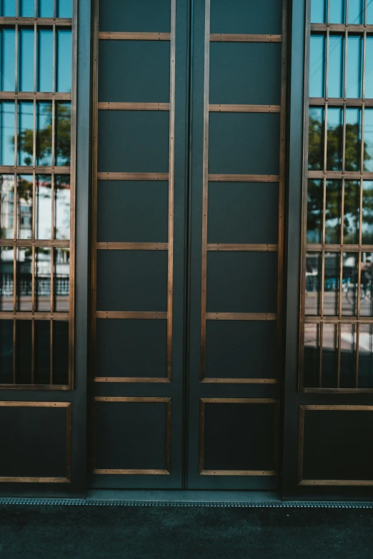 the front doors to a building with glass