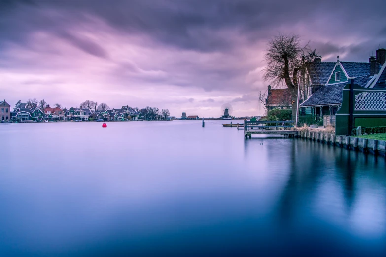 an empty lake is pictured against a cloudy sky