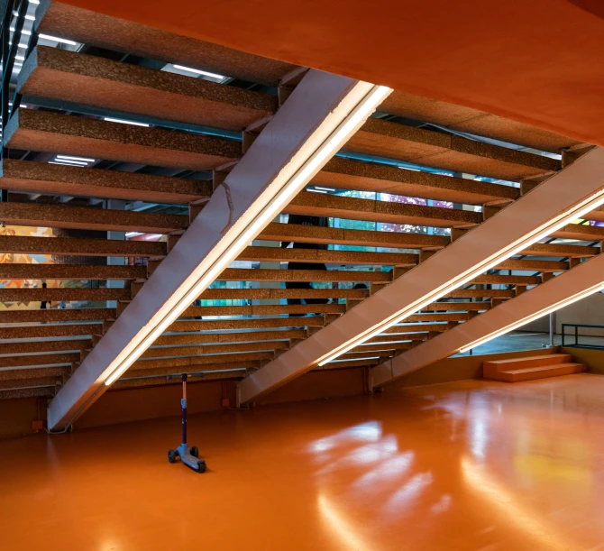 an orange floor and stairs that have been designed