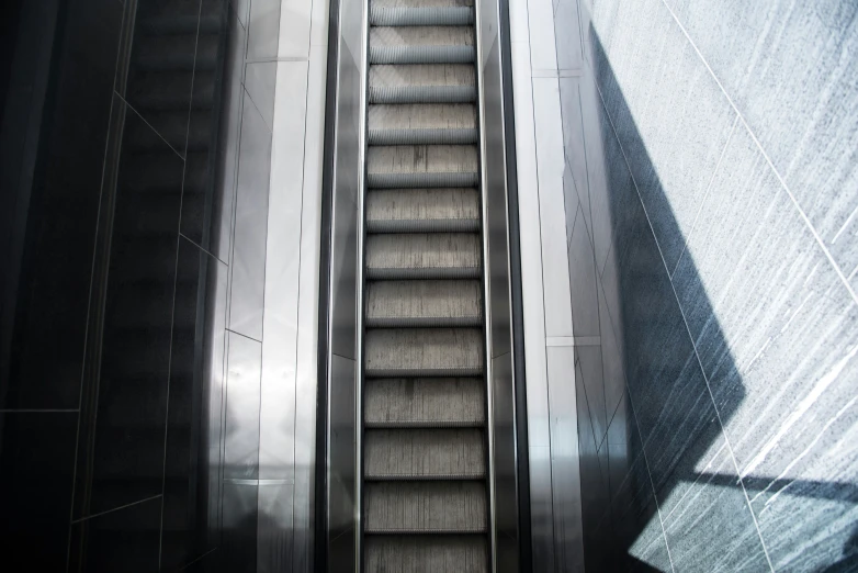 an escalator sitting inside of a building with its doors opened