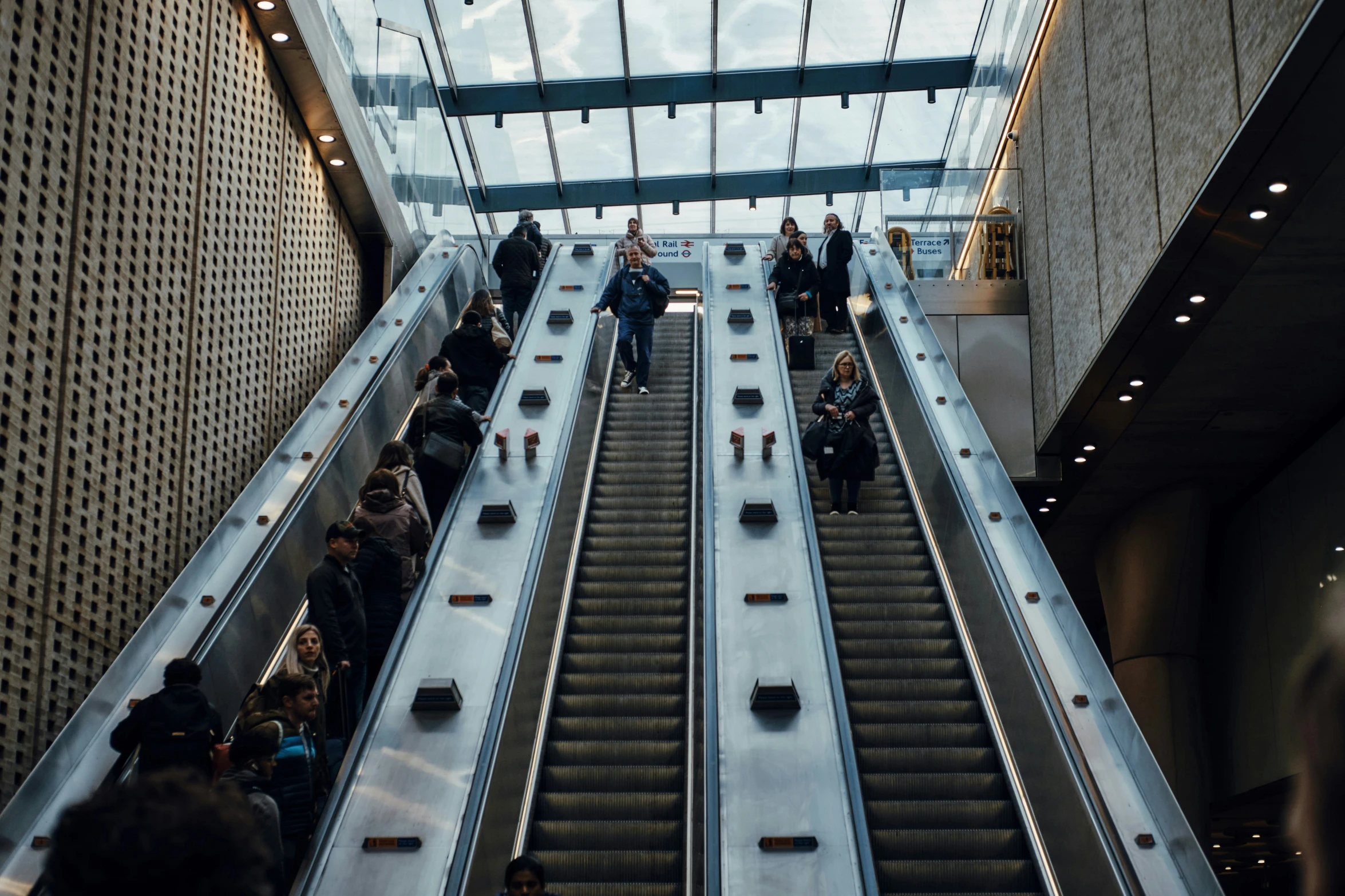 there are people walking up an escalator