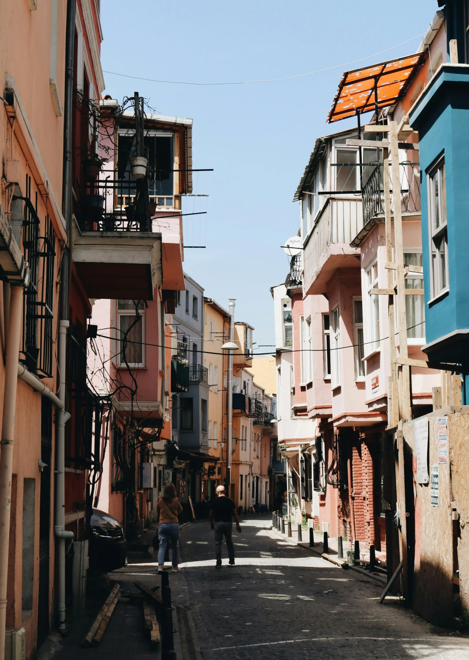 an old city street with people walking on it