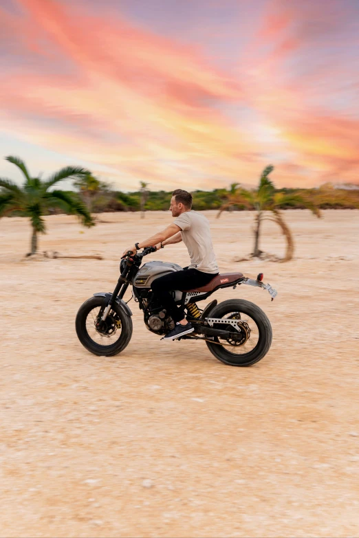 man with white t shirt and black jeans on motorcycle