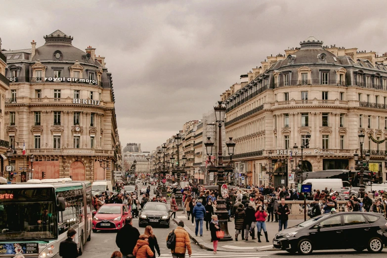 a group of people walking down a city street