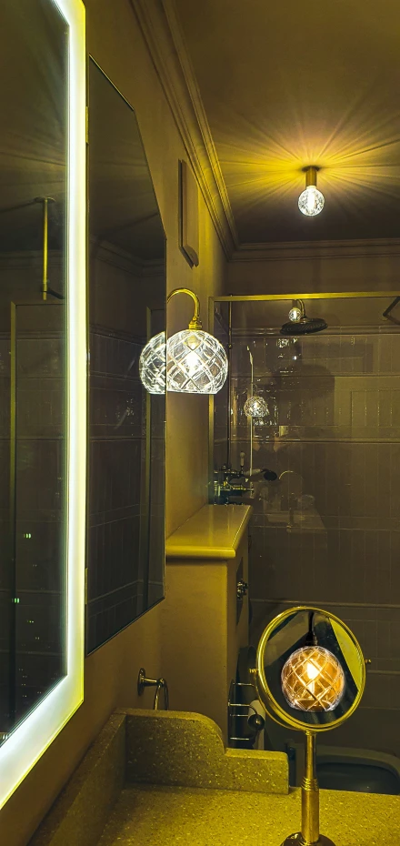 a bathroom with a sink and lights next to a mirror