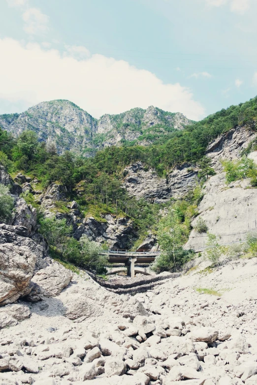 a bench sits in the middle of rocks and trees