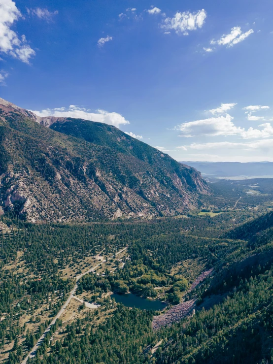 an aerial view of a valley near mountains