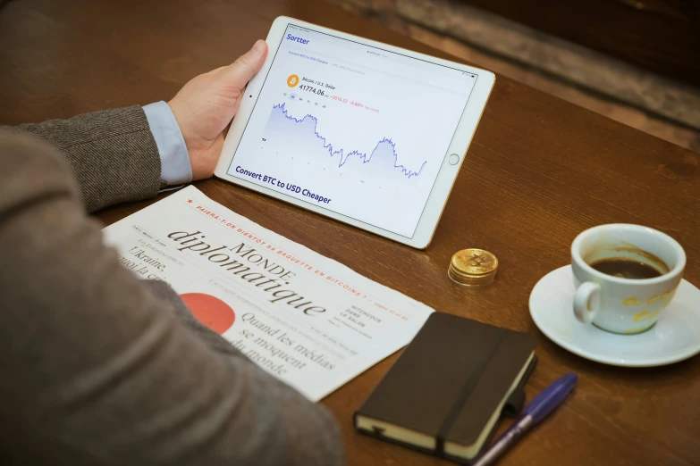 a man on his desk working with a tablet