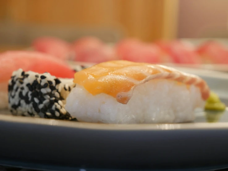 the sushi was served with sesame seeds and pepper