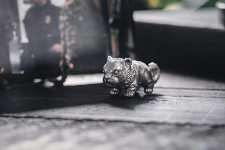 a small model toy tiger on the ground