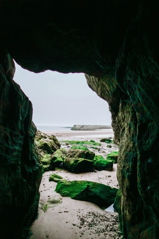 an open cave with the ocean in the background