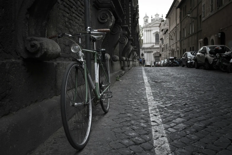a bicycle is leaning on a stone wall