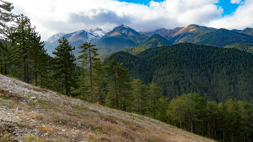 a view of mountains on a cloudy day