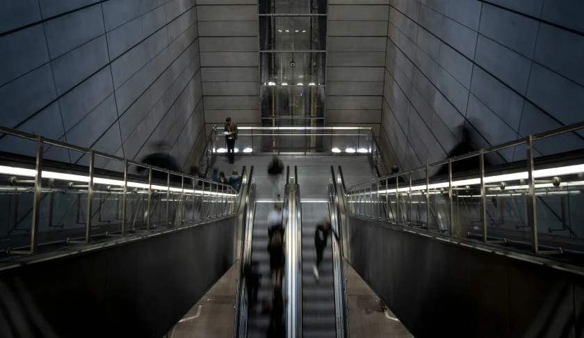 escalator in metro station with people moving down