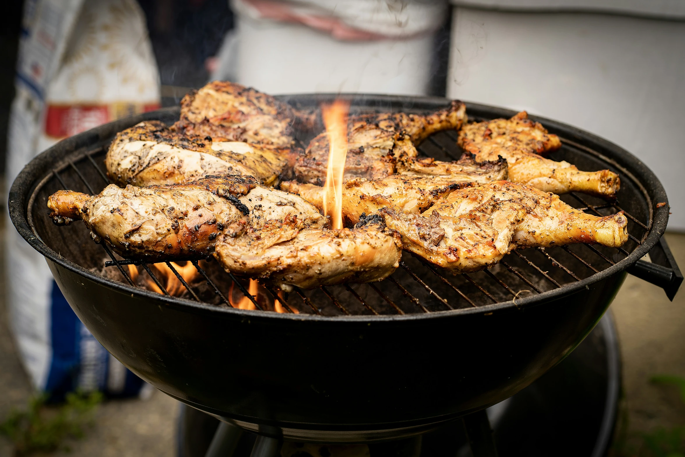 chicken legs on top of a grill with other items