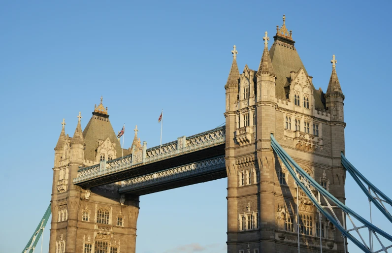 a tall bridge with many windows has a clock