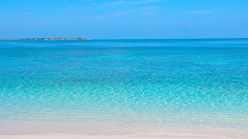 an ocean scene with some clear blue water