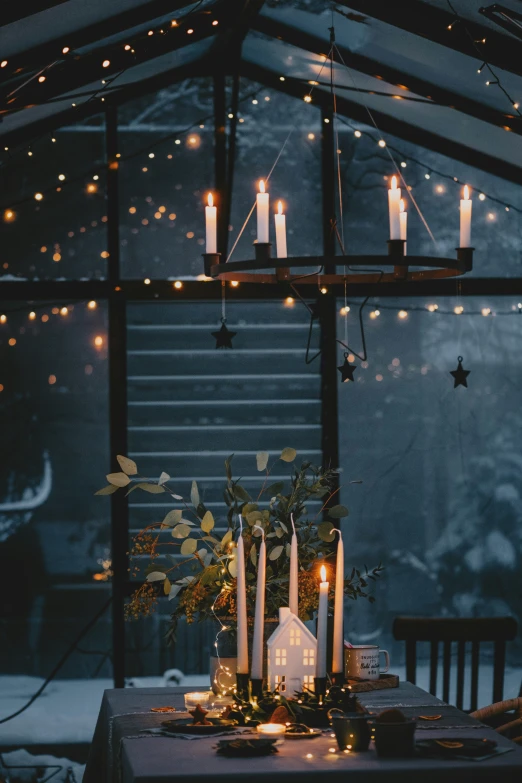 a table with candles on it near a staircase