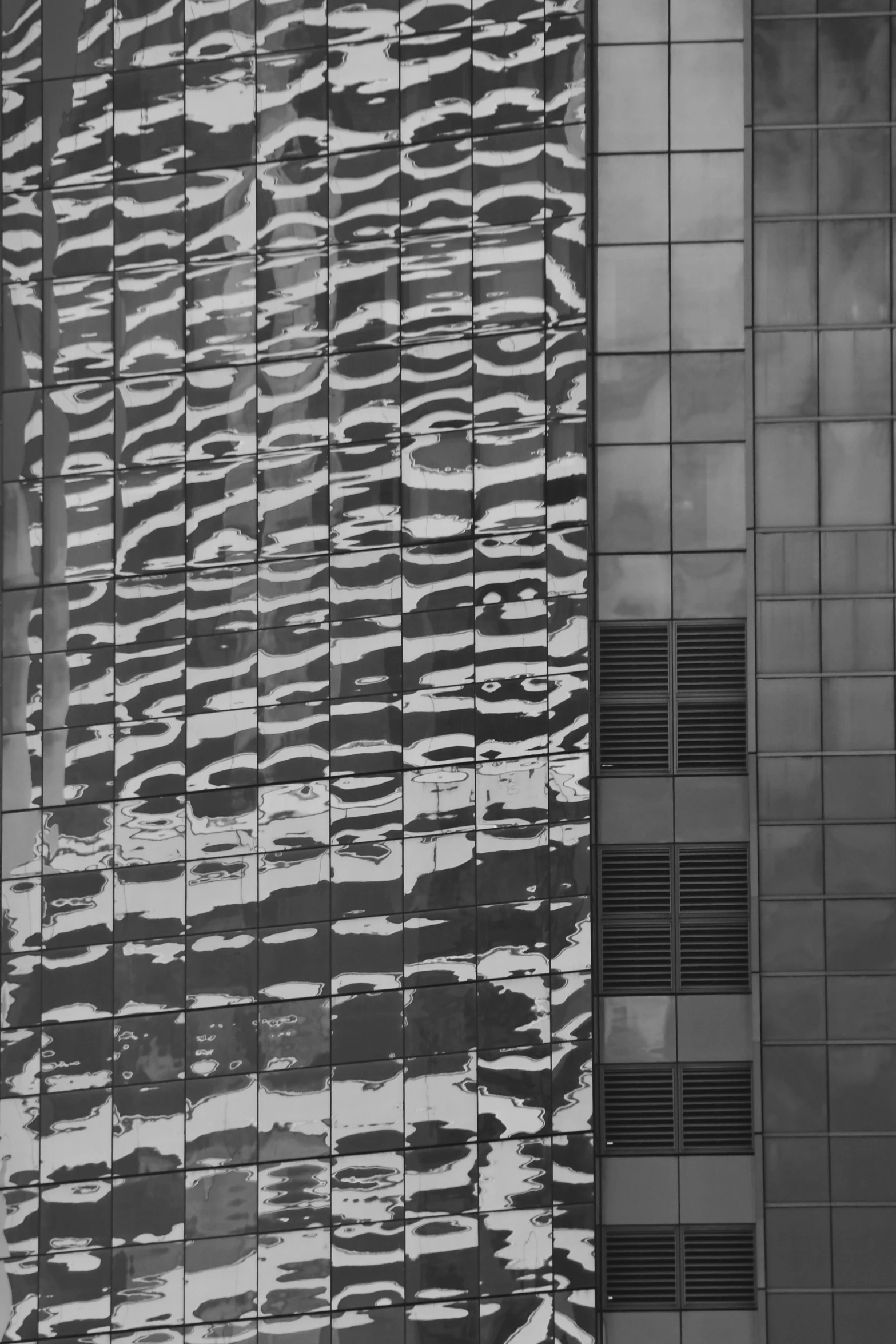 a tall building reflecting its glass front