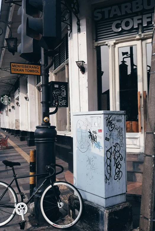 an empty street with a bicycle and a box