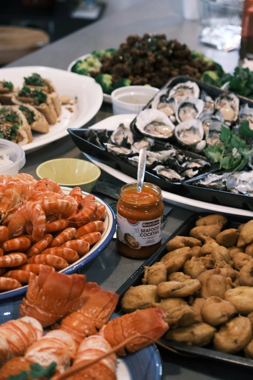 several plates full of seafood and vegetables displayed