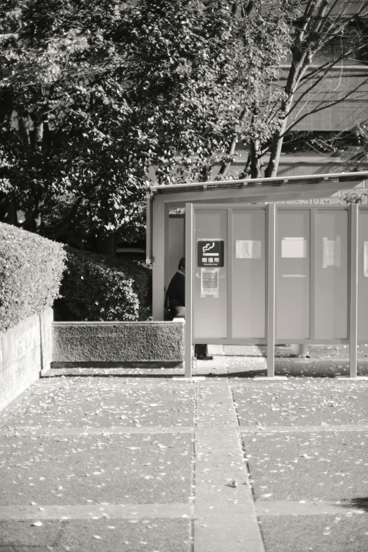 there is a toilet in a very large outdoor bathroom