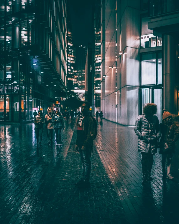 people are walking in the rain along the side of the road