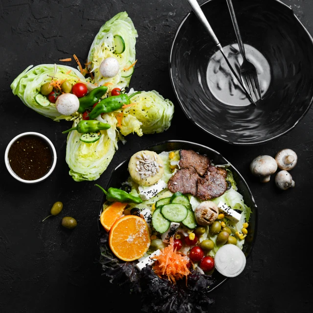 food is served in two plates and topped with silver chopsticks