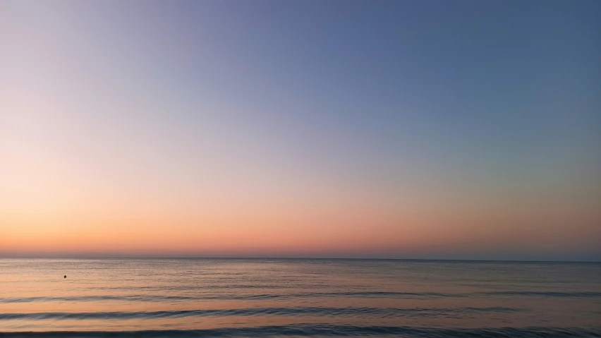 a group of people sit on surfboards near the water