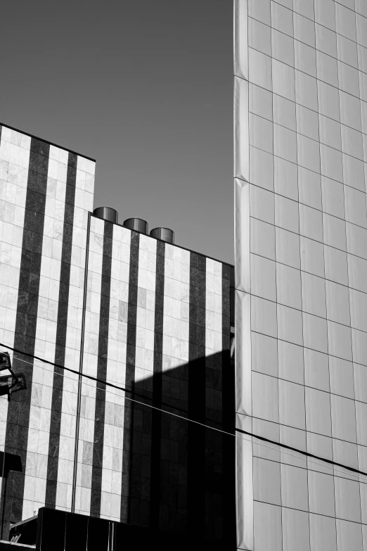 two tall buildings have been painted white and gray