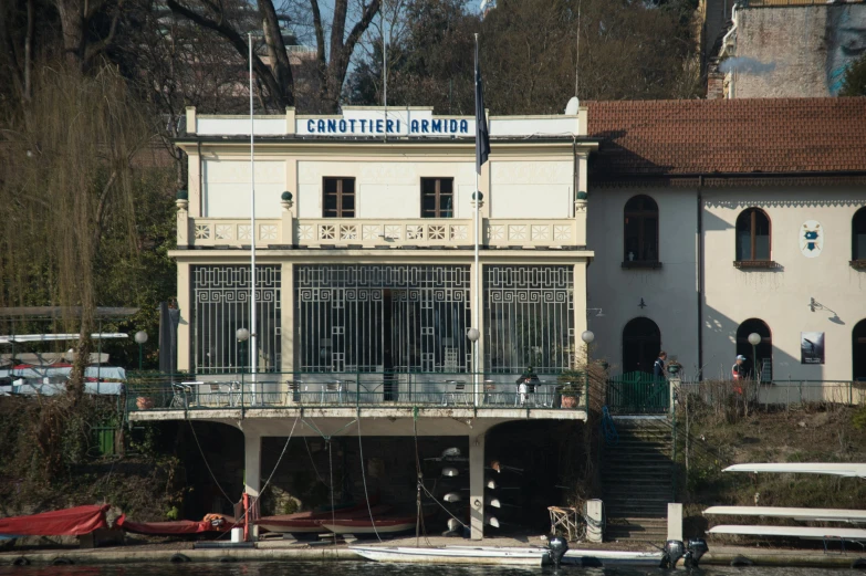 an old building next to a boat on the water