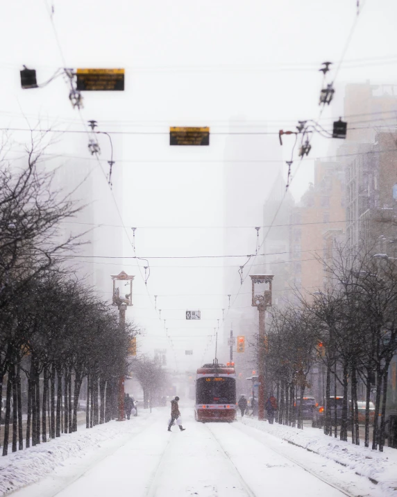 a person walking across a snow covered street