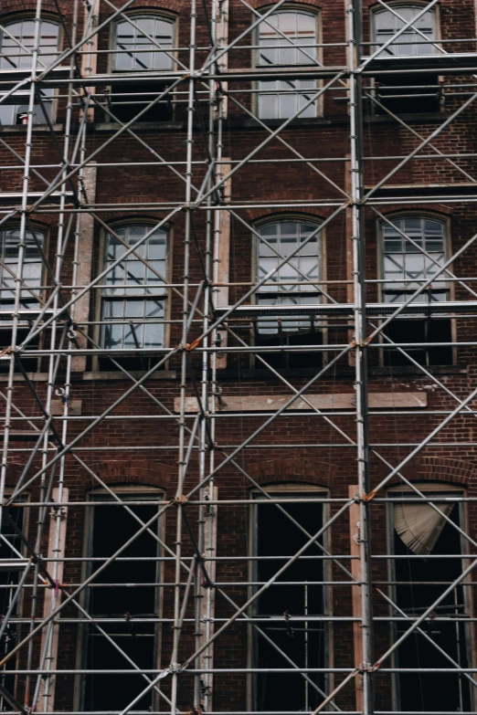 a large brick building with scaffolding on the side of it