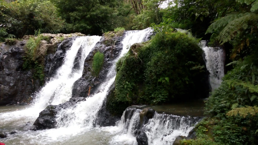 the waterfall is flowing water from rocks