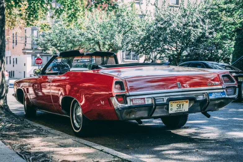 the vintage car has a surfboard attached to the top of it